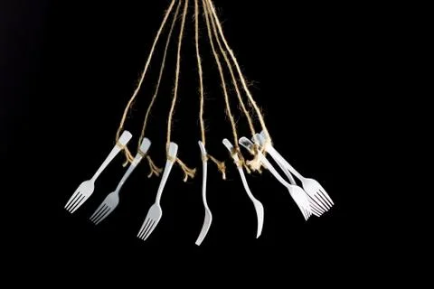 White plastic fork on black background Stock Photos
