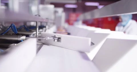 White plastic guides on an automated packaging machine, Food Factory Stock Footage 340017700