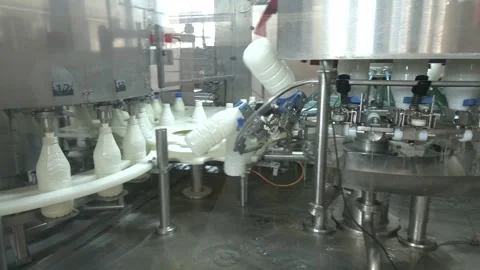 White plastic milk bottles on the conveyor on a modern dairy plant. Stock Footage 313225086