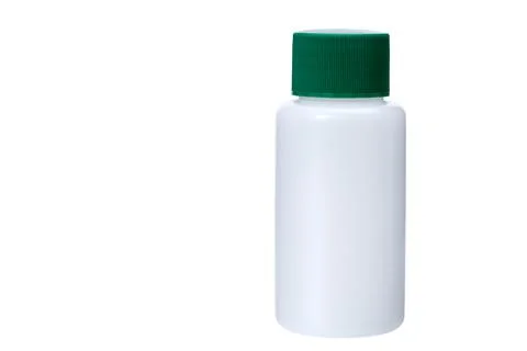 White plastic non transparent bottle with green cap for medical products. Stock Photos