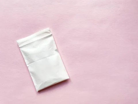 White plastic packaging on a pink background. Foto stock