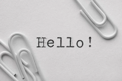 White plastic paper clips with Hello word Stock Photos