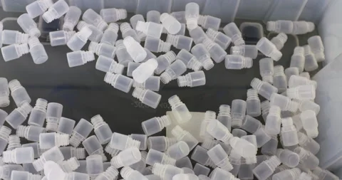 White plastic parts fall into one heap. Stock Footage 329222836