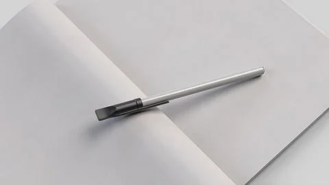 White plastic pen in notebook with white sheet, side view Stock Illustration