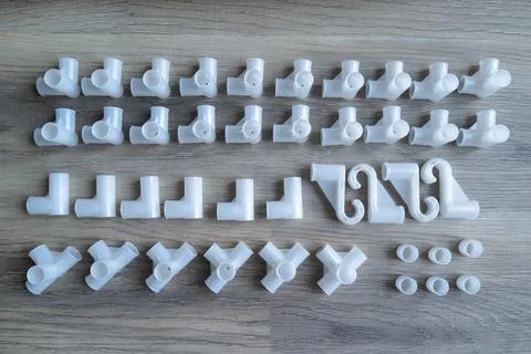 White plastic pipe connectors for DIY projects Stock Photos