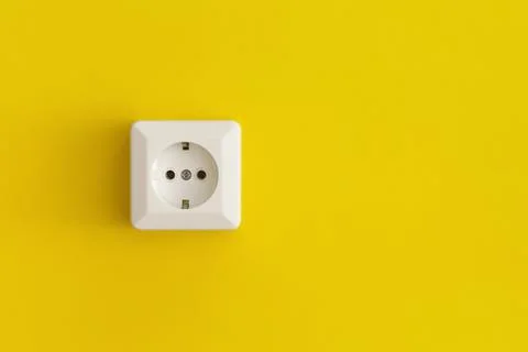 White plastic power socket on a yellow background Stock Photos