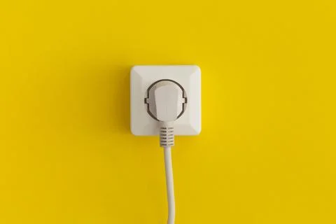 White plastic power socket on a yellow background Fotos de archivo