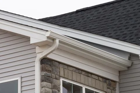 White plastic rain guttering system guttering drainage pipe exterior backgrou Stock Photos