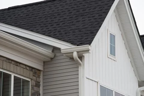 White plastic rain guttering system guttering drainage pipe exterior background Stock Photos