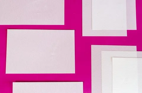 White plastic rectangles on a colored background. Repeated blank textured geo Foto stock