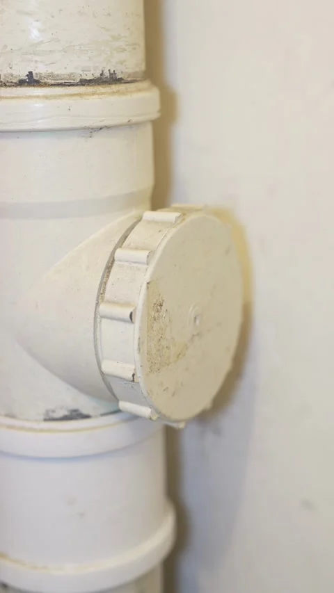 White plastic sewer pipe with a round screw cap lid Stock Footage 332982192