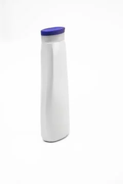White plastic shampoo bottle with blue cap on white background Stock Photos