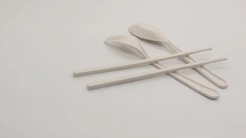 White plastic spoon, fork and chopsticks isolated Stock Photos