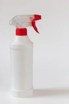White plastic spray bottle with red trigger isolated on light background Stock Photos