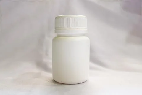 White Plastic Supplement Bottle with Ribbed Cap Stock Photos
