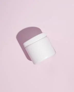 White plastic supplement container on pink background. Package mockup blank Stock Photos