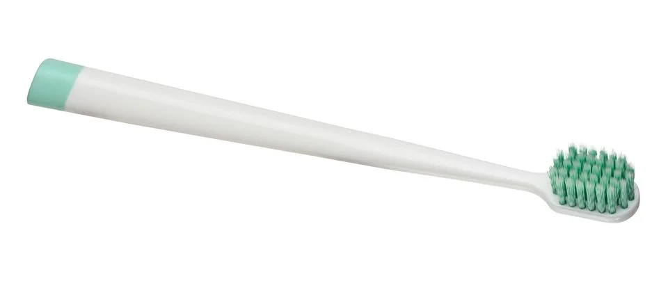 White plastic toothbrush with turquoise insert on the handle and thick gree.. Photos