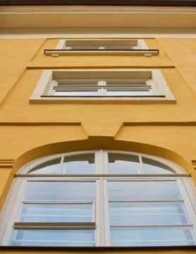 White plastic window on the yellow facade Stock Photos