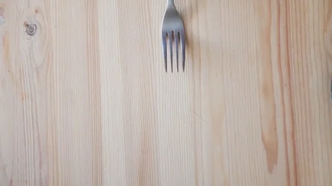 White plate and fork on old wooden table, top view Stock Footage 74467941