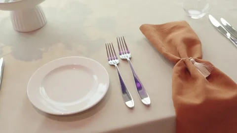 A white plate and forks on a table. Stock Footage 306436450