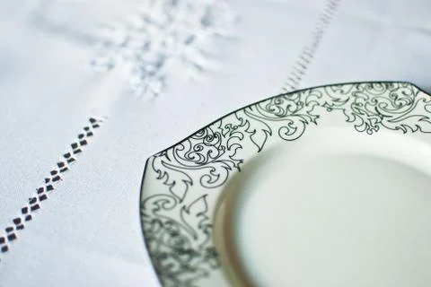 White plate with black patterns on white background. Isolated  Stock Photos