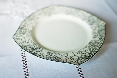 White plate with black patterns on white background. Isolated  Stock Photos