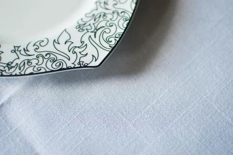 White plate with black patterns on white background. Isolated  Stock Photos