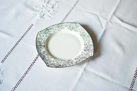White plate with black patterns on white background. Isolated  Stock Photos