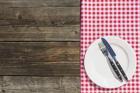 White plate checkered table cloth wooden textured plank Stock Photos