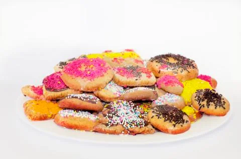 White plate with colored biscuits Stock Photos