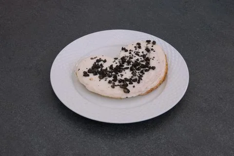A white plate with a cookie on it Stock Photos
