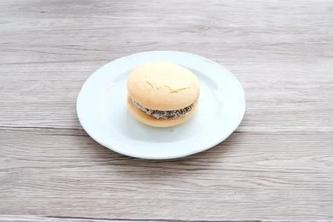 A white plate with a cookie on it Stock Photos