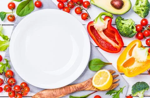 White plate copy space background and vegetables ingredients top view background Stock Photos