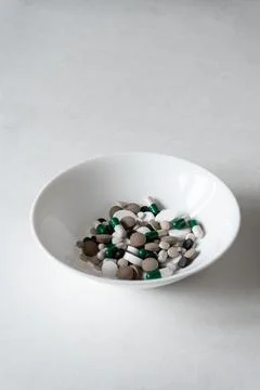 White plate with Different tablets and pills at white background Stock Photos