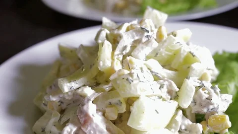On a white plate is a mixed salad with white sauce Stock Footage 111685100