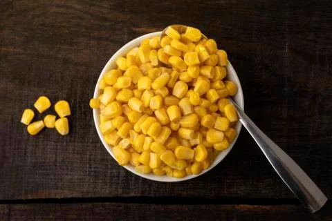White plate on rustic table with vegetables. Stock Photos