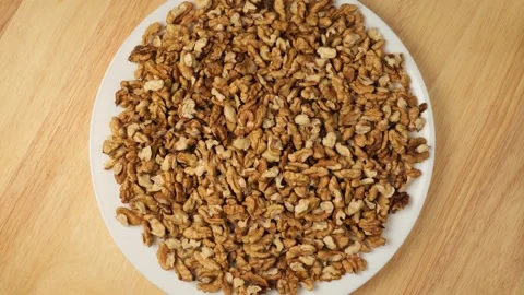 White plate with shelled walnuts rotating Stock Footage 341281226