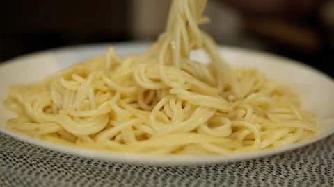 White plate with spaghetti on the kitchen table, close-up Stock Footage 132418757