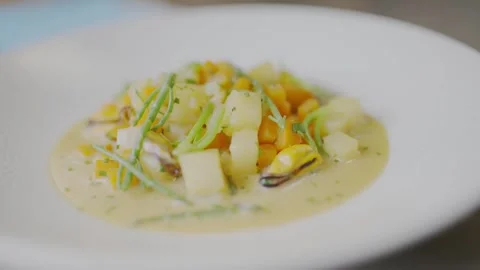 A white plate with a yellowish colored food on it Stock Footage 306576853