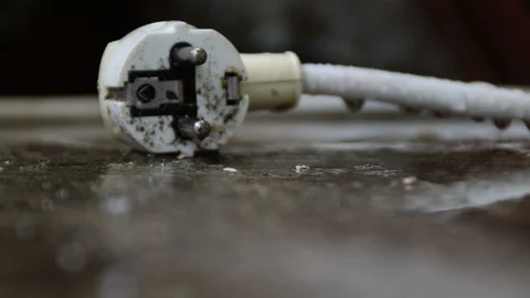 White plug lying on the ground during a rain Stock Footage 114510612