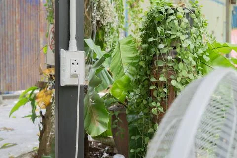 White plug socket setting at outdoor with electric fan power cord on steel .. Stock Photos