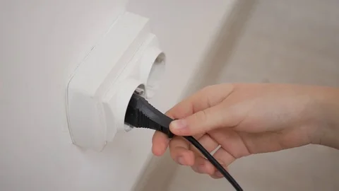 White plug in a wall socket rapid video Stock Footage 103286275