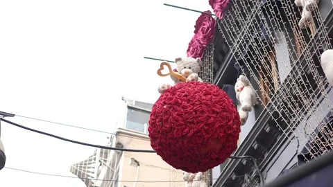 White plush teddy bear on big flower ball Stock Footage 176328696