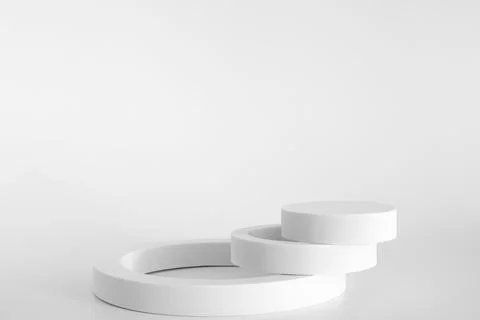White podium on the white background, simple geometric forms. Podium for prod Stock Photos