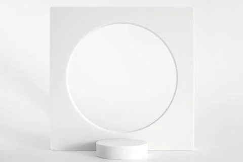 White podium on the white background, simple geometric forms. Podium for prod Stock Photos