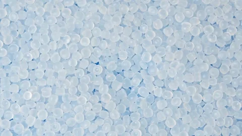White polyethylene granules move in close up for medical, packaging and Stock Footage 347047996