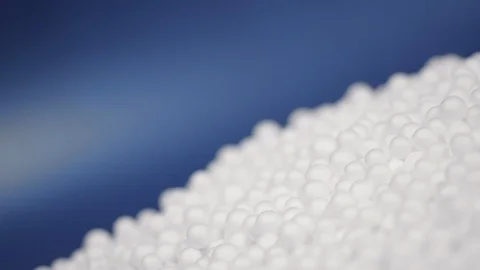 White polystyrene foam beads ball drop Stock Footage 129278657