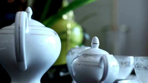 White porcelain tea set sits elegantly on a table Video stock 333817416