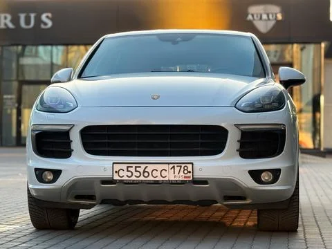 White Porsche Cayenne S E2 958 sports SUV in parked lot. Stock Photos