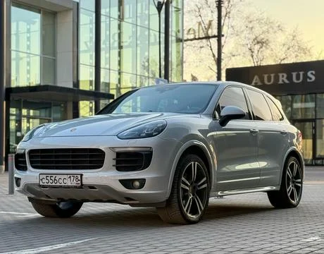White Porsche Cayenne S E2 958 sports SUV in parked lot. Stock Photos